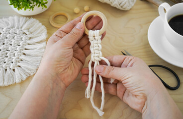 A Hand-Made Macrame amulet with Wooden Rings in a Beautiful Background Setting the Mood for...