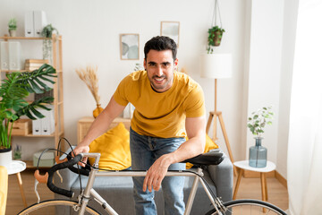 Fototapeta na wymiar Smiling man with bicycle at home.