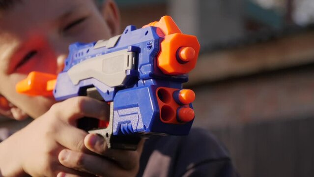 a little boy shoots a toy gun
