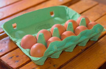 Eggs in a box on a wooden table