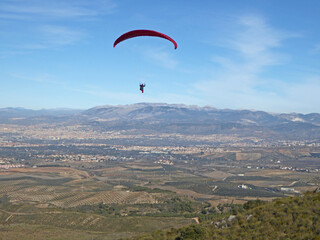 Fototapeta na wymiar Paraglider flying from Padul in Spain 