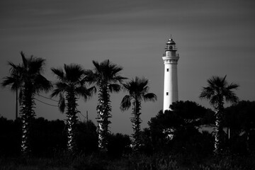 Lighthouse during sunset. Black and white photo - obrazy, fototapety, plakaty