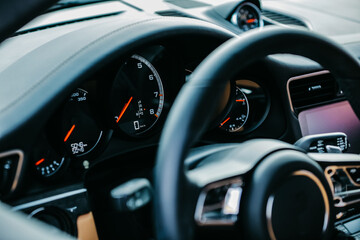 Fototapeta na wymiar Modern supercar interior with the leather panel, sport seats, multimedia, and digital dashboard