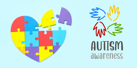 Heart made of jigsaw puzzle pieces on light blue background. World Autism Awareness Day