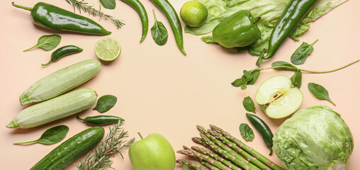 Frame made of different fresh vegetables and fruits on beige background