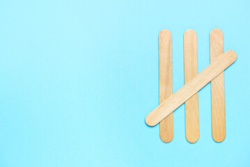 Composition with ice cream sticks on color background
