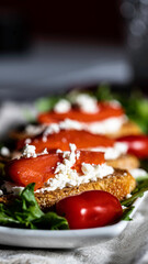 Smoked salmon and goat cheese crostini served on a bed of salad greens