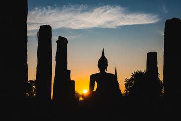 Historic Town of Sukhothai temple park, Ancient Buddha Statue at sunset Sukhothai historical park, Mahathat Temple