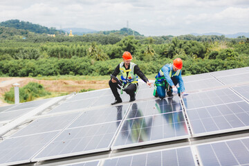 Fototapeta premium Technician engineer planning to setting solar panel on the roof of the building to work at full efficiency, Using solar cells for energy saving to save and protect environment. Renewable energy