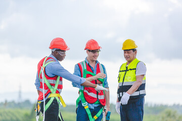 Technician engineer service meeting and checking solar cell on rooftop of industrial factory. Inspection worker repair solar cell panels. Clean Renewable energy, Ecology and alternative power concept