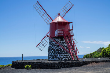 Red windmill / A red windmill on the coast of Pico island, Azores. - 601194605