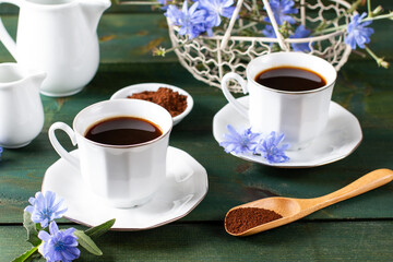 Hot natural chicory caffeine free drink in a cup on a table. Healthy alternative replacement for coffee, caffeine. Blue chicory flower