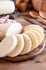 Preparing dumplings (knedliky) (steamed and sliced bread-like) on a board are typical of Czech cuisine.