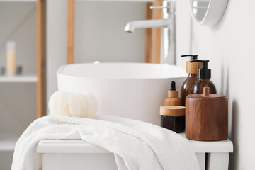 Different cosmetic products near sink in bathroom