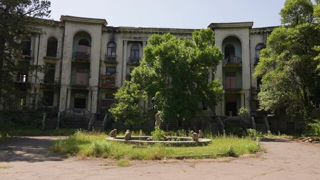 Abandoned Soviet style sanatorium in Tskaltubo, Georgia - fountain in foreground