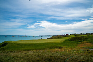 a golf course by water