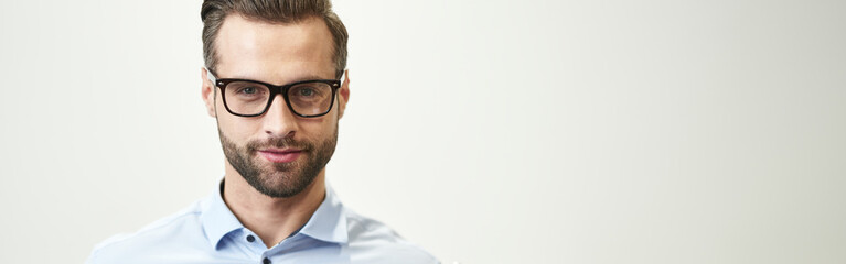 Confident handsome man with gadget on white background