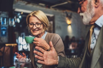 Mature Woman and Senior Man couple Bond Over Coffee at Cafe sit talk