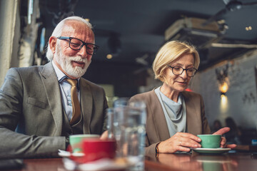 Mature Woman and Senior Man couple Bond Over Coffee at Cafe sit talk