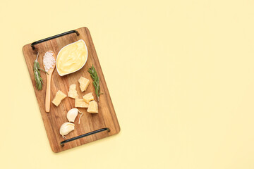 Composition with creamy pizza sauce and ingredients on yellow background