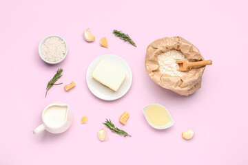 Composition with ingredients for bechamel sauce on pink background