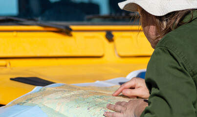On a Yellow 4x4: Travel Photo of a Woman Navigating with a Map