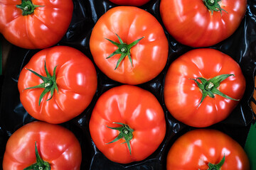 group of ripe red tomatoes in grocery produce 