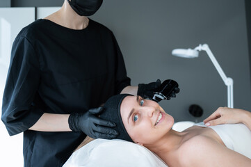 Woman on ultrasonic cleaning procedure. Hardware cosmetology. 