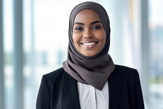 Smiling young black businesswoman wearing a hijab looking at the camera. Generative AI