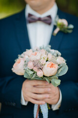 groom holding flowers