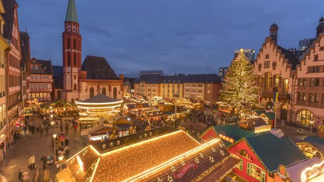 People at busy Christmas Market in Romerberg Square at dusk, Frankfurt am Main, Hesse