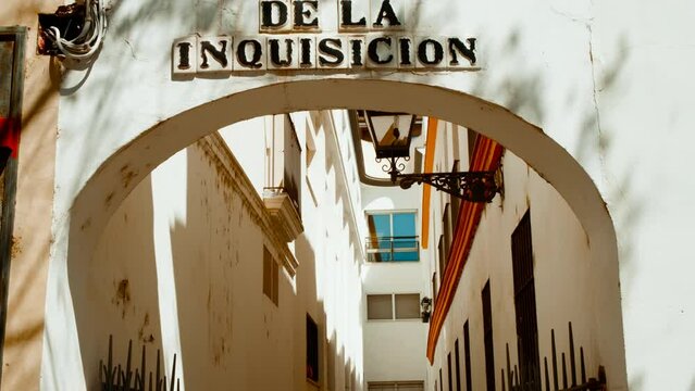 Calle de la Inquisicion, Traiana, Seville, Andalusia, Spain, a historic street with cobbled pavement, lined with traditional houses and tapas bars