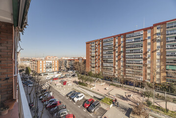 Facades of buildings in a large open area with parks 5