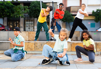 Fototapeta premium Modern tweens dancing on summer street. Urban lifestyle. Hip-hop generation