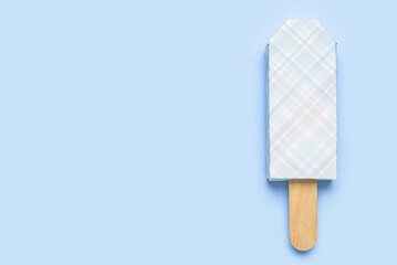 Ice cream in package and stick on blue background