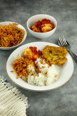 Nasi Uduk is an style steamed rice cooked in coconut milk usually eaten with side dishes of tempeh, vermicelli, eggs, and spicy potatoes, This food is typical food from Jakarta .