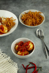 Nasi Uduk is an style steamed rice cooked in coconut milk usually eaten with side dishes of tempeh, vermicelli, eggs, and spicy potatoes, This food is typical food from Jakarta .