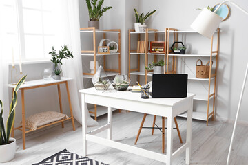 Interior of office with workplace, florariums and houseplants