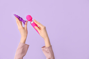 Woman with anal plug and vibrator on lilac background
