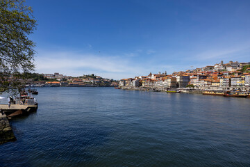 Fototapeta na wymiar Panoramic view of Douro river and the cityscape of city of Porto in the background, Porto, Portugal