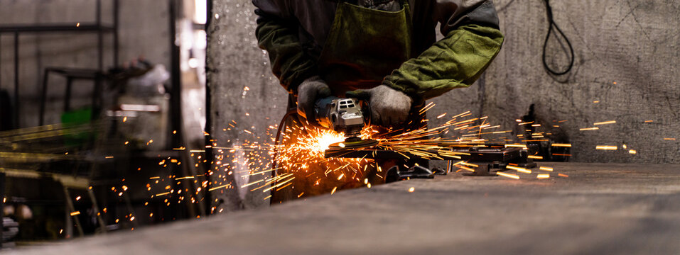Metal processing with angle grinder. Sparks in metalworking.