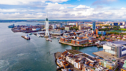 Aerial view of the sail-shaped Spinnaker Tower in Portsmouth Harbor in the south of England on the Channel coast - Gunwharf Quays modern shopping mall in a residential waterfront area - obrazy, fototapety, plakaty
