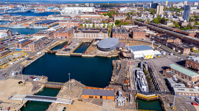 Aerial view of Portsmouth Historic Dockyard and the Royal Navy's ancient HMS Victory, the HMS M33 as well as the Mary Rose Museum on the English Channel coast in the south of England, United Kingdom