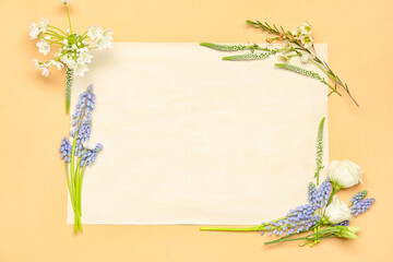 Blank greeting card with different flowers on beige background