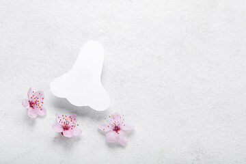 Paper nose with flowers on white background. Seasonal allergy concept
