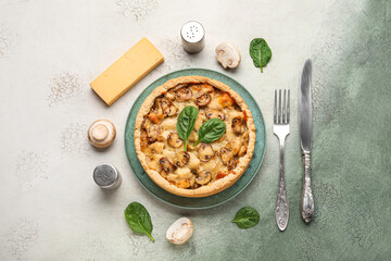 Mushroom pie with spinach leaves and champignons on dark green grunge background