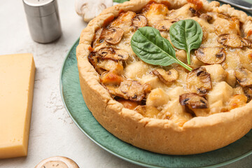 Mushroom pie with spinach leaves and champignons on dark green grunge background