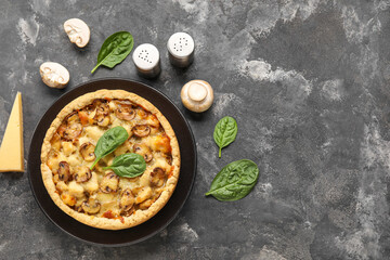 Mushroom pie with spinach leaves and champignons on dark grey grunge background