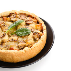 Mushroom pie with spinach leaves and plate on white background