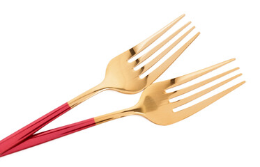 Golden forks with red handles on white background